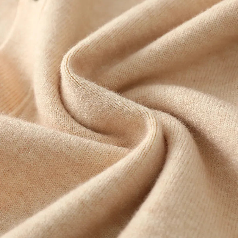 Man wearing a loose beige Andy velvet V-neck cardigan coat with long sleeves