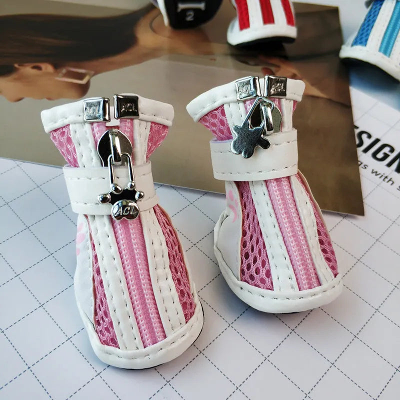 Blue zip-up cloth dog shoes with non-slip soles from a four-pair pack.