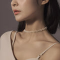 Hand-woven white pearl necklace with adjustable bean chain on display