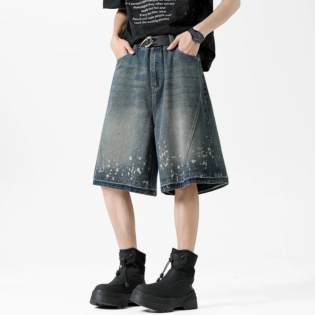 Men's retro blue washed denim shorts with ripped and splash ink distressing detail on straight-leg cut