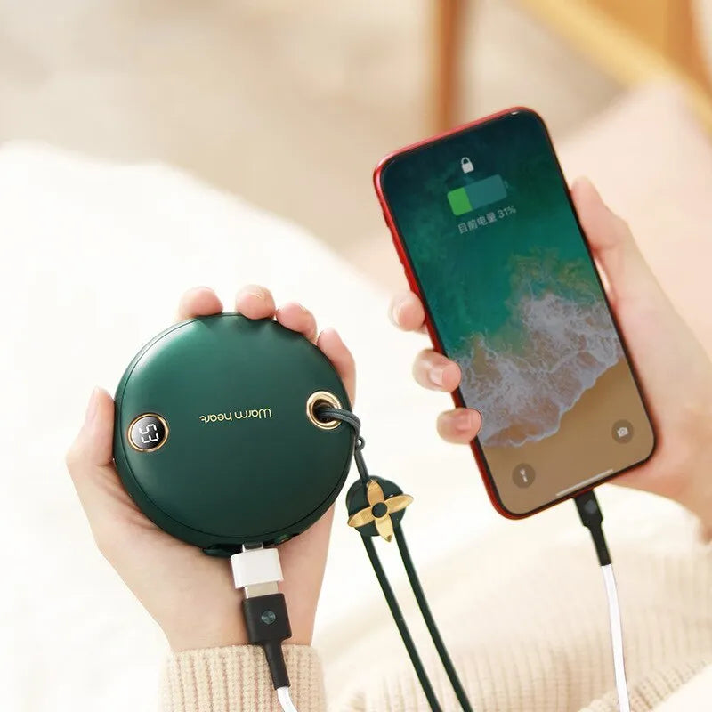 Green 5000mAh hand warmer power bank with digital display, shown next to its included USB charging cable.
