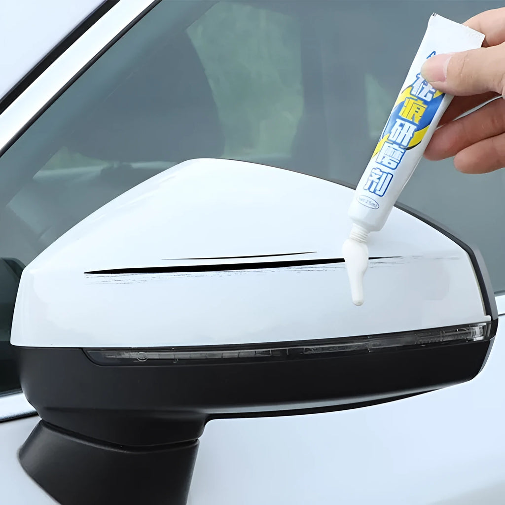 Automotive scratch repair kit showing touch-up paint pen, wax tube, sandpaper, and sponge for car paint touch-up.