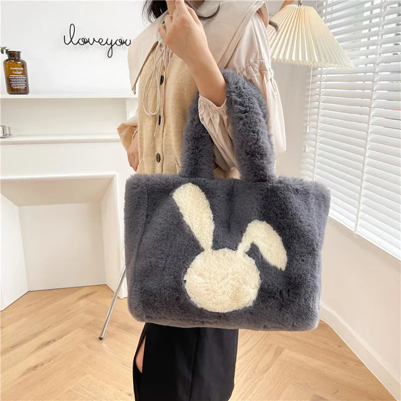 Cartoon rabbit ears design on a solid colour plush tote bag for women.