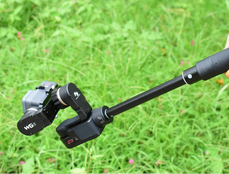 Black retractable aluminium selfie stick extended to full length showing tripod mount.