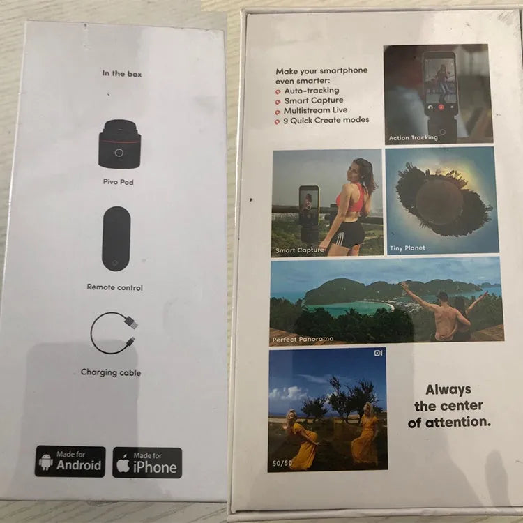 Black PIVO facial tracking smartphone mount on a table, showing 360-degree rotation mechanism.