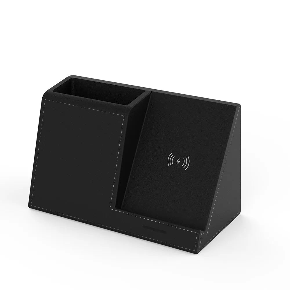 Black leather wireless charging station with pen holder slots showing phone charging on surface