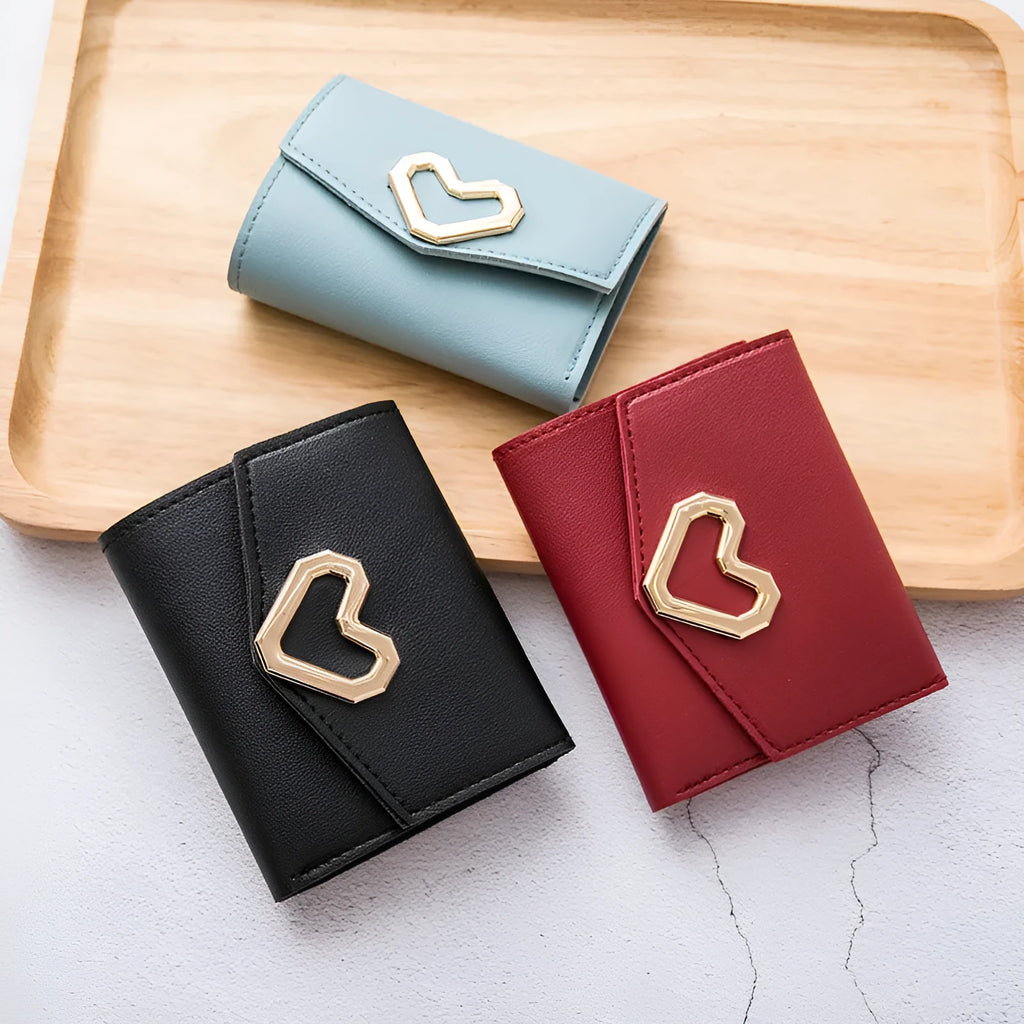 Ladies tri-fold PU leather wallet with magnetic buckle, card slots, ID space, coin pocket, and heart decoration