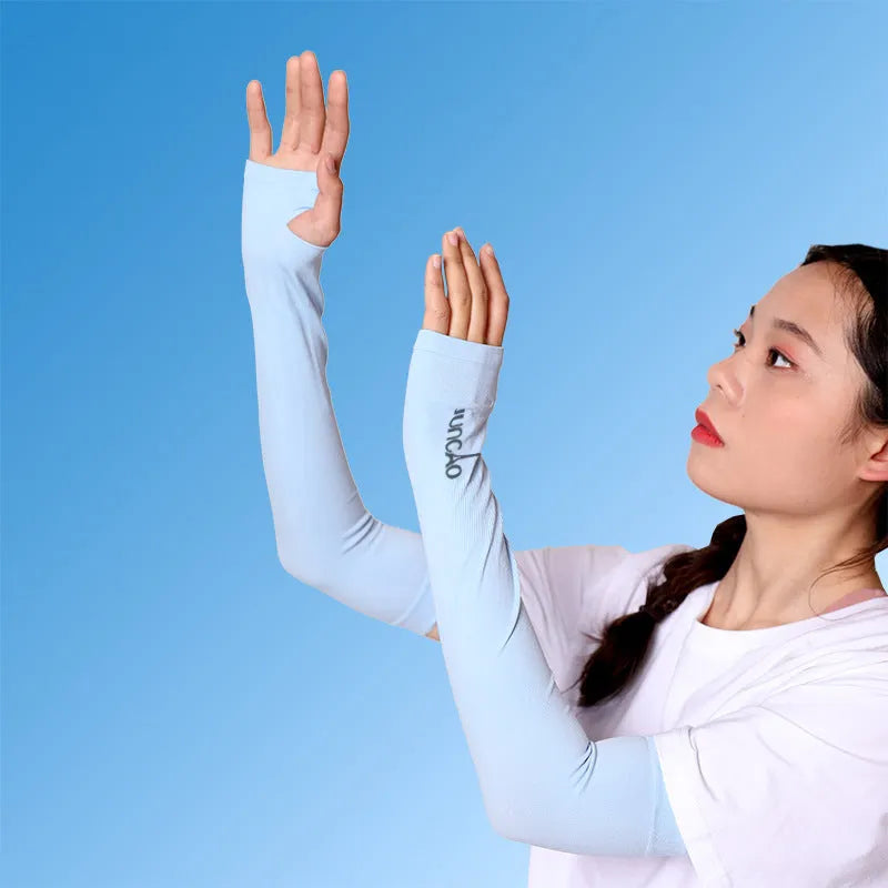 A person wearing a light grey nylon sun protection oversleeve on their arm with open fingers, suitable for driving.