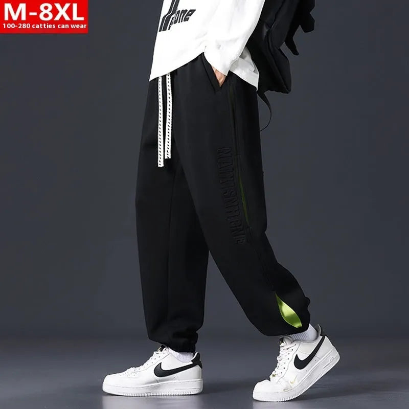 Men's loose-fit cotton trousers with stitching print design and ankle band in grey green.
