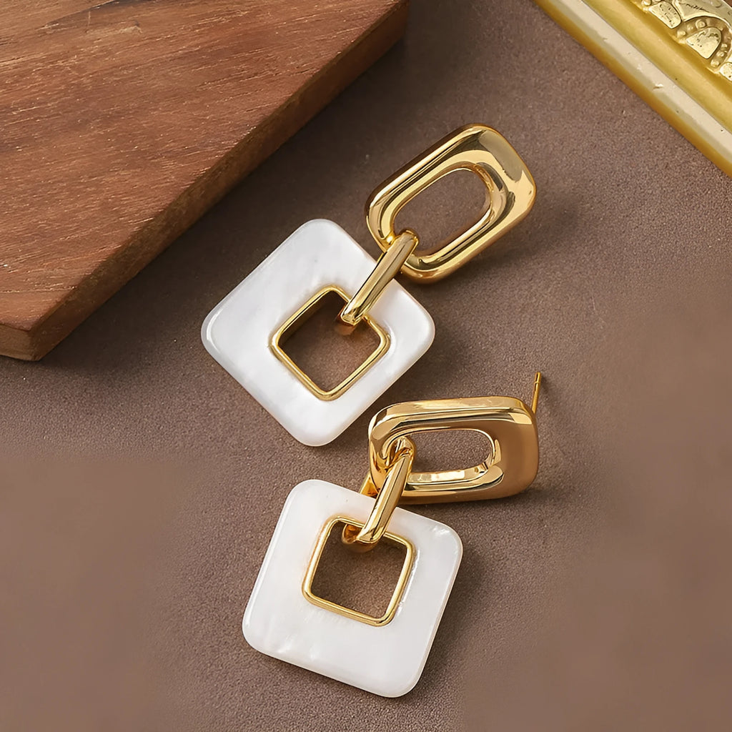Copper geometric square earrings with hollow design and chamfered corners in metallic finish