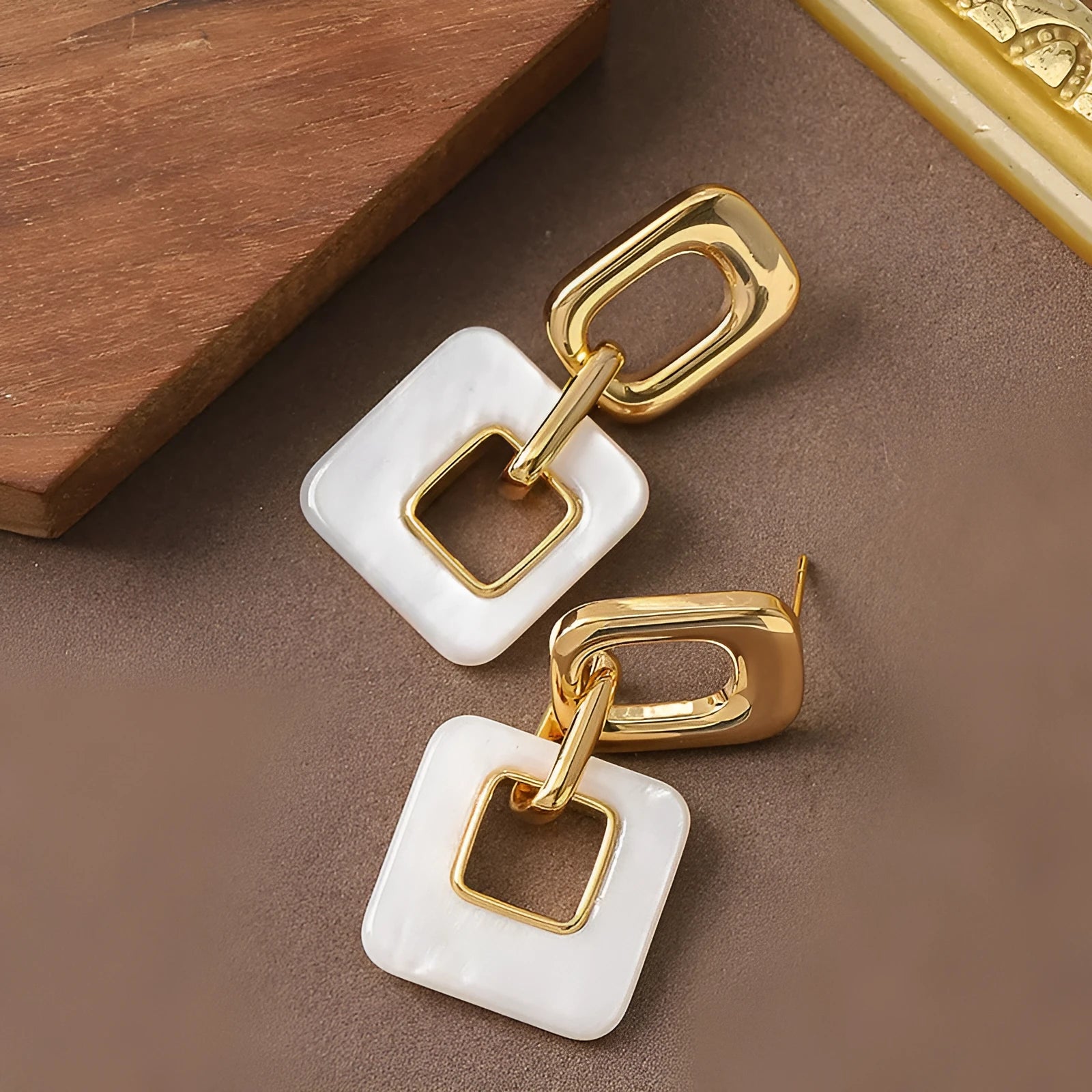 Copper geometric square earrings with hollow design and chamfered corners in metallic finish