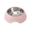 Set of four coloured stainless steel pet bowls with non-slip bases on a floor.