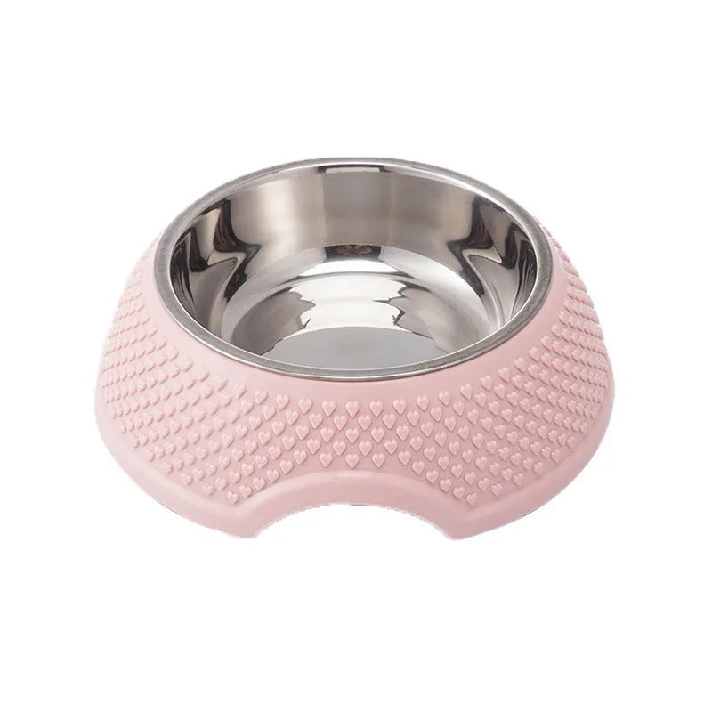 Set of four coloured stainless steel pet bowls with non-slip bases on a floor.