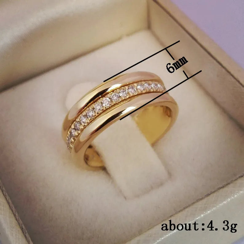 Gold plated copper geometric ring with inlaid zircon stone on white background