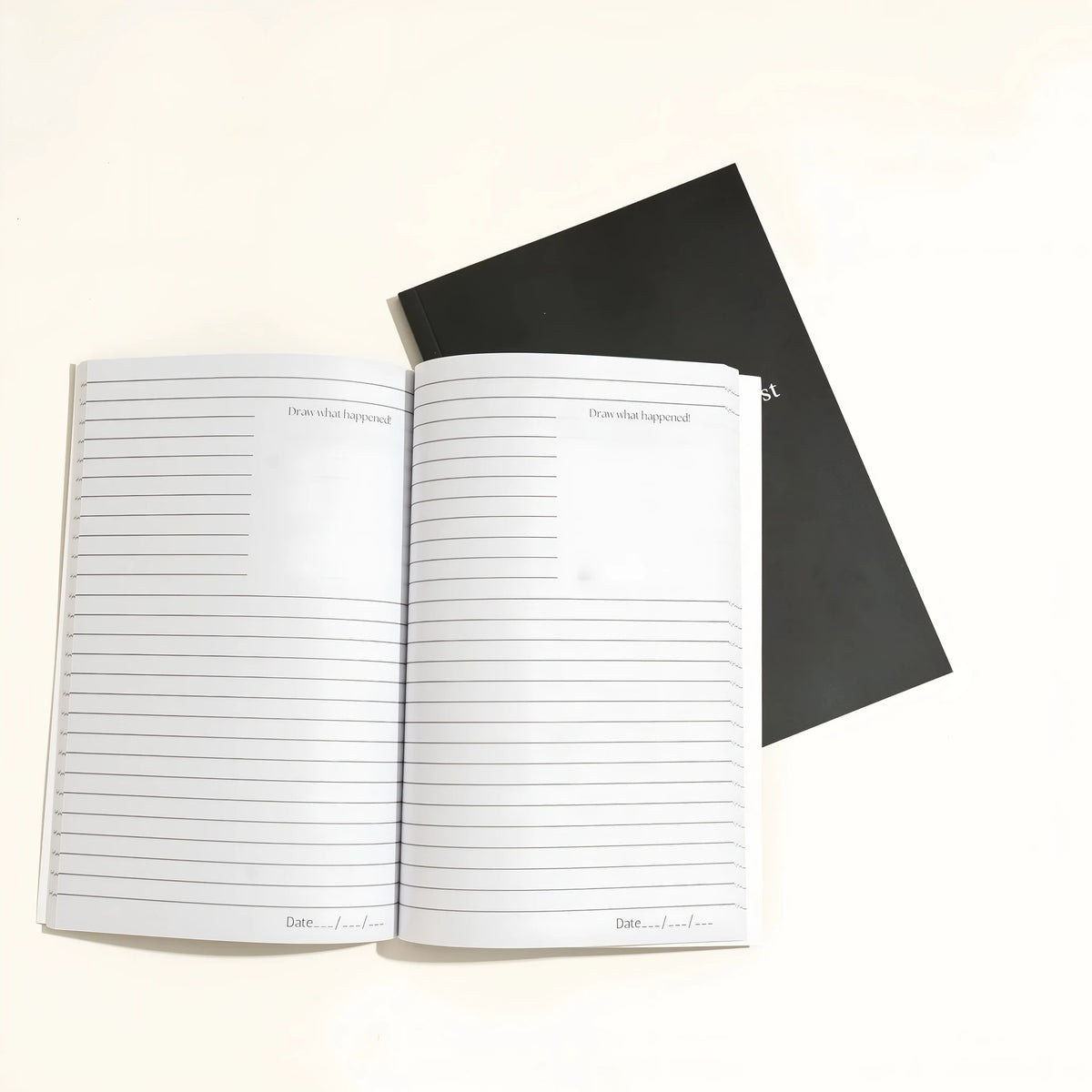 Black cover Dream Journal notebook with Business Simplicity design, open to show dot grid interior pages.
