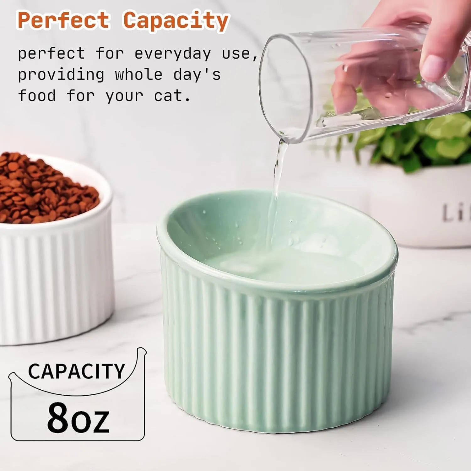 Elevated ceramic cat bowl in green, shown at a tilted angle to highlight its raised base and round feeding dish.