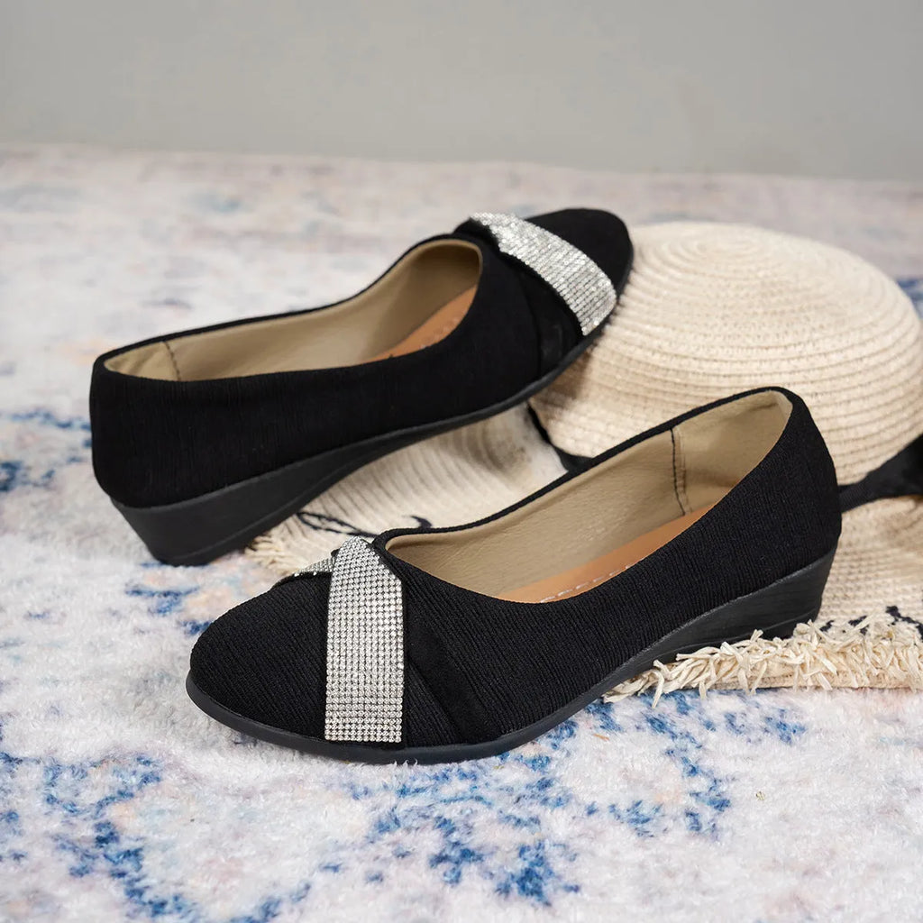 Black women's slip-on casual shoes with rhinestones on fabric upper and a chunky heel.