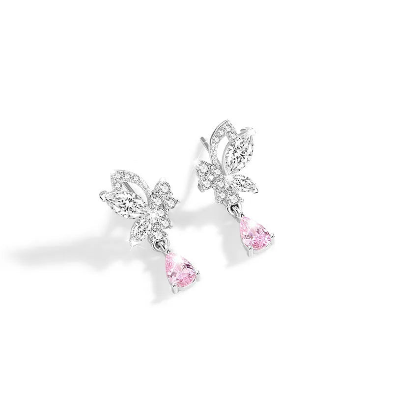 A pair of silver stud earrings featuring a butterfly design with crystal details on a white background.