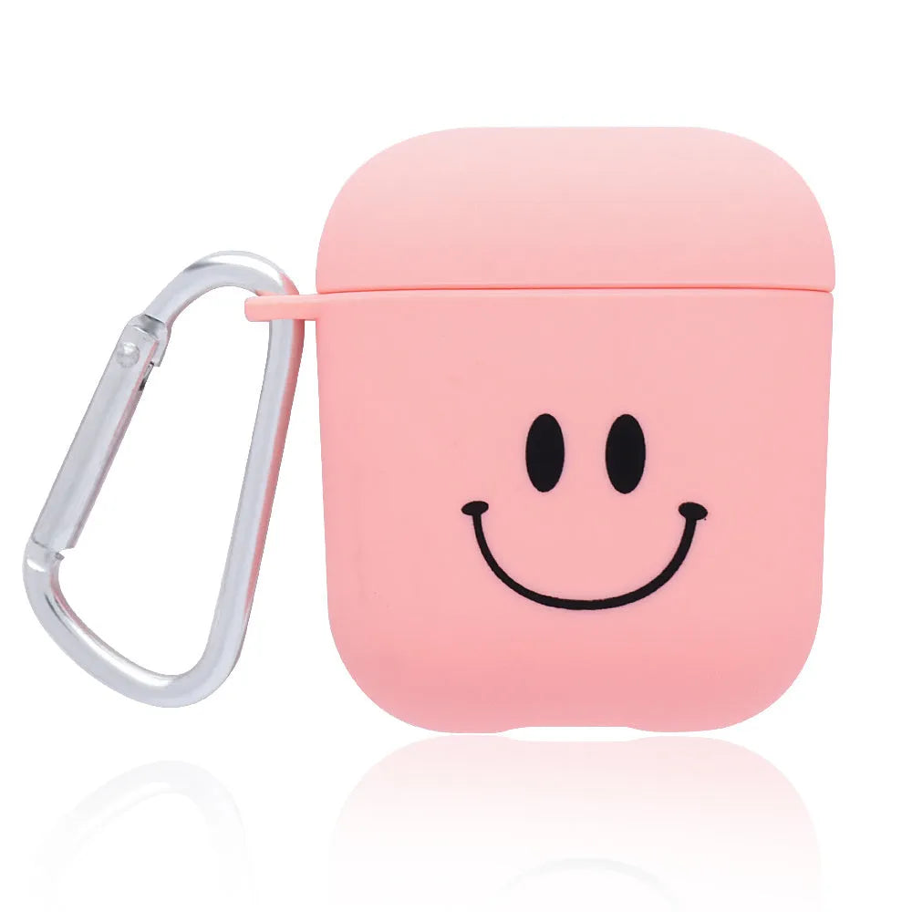 Black AirPods hard case with a smiley face design next to a pink case with a flower pattern.