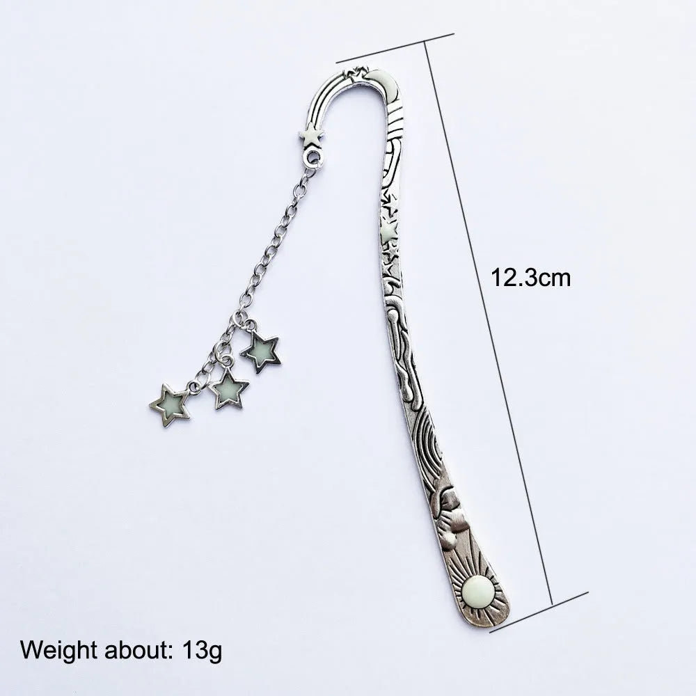 Retro five-pointed star glowing metal bookmark in ancient silver or bronze with sun, moon and stars design