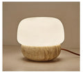 Cream coloured retro bedside lamp with button switch on small table