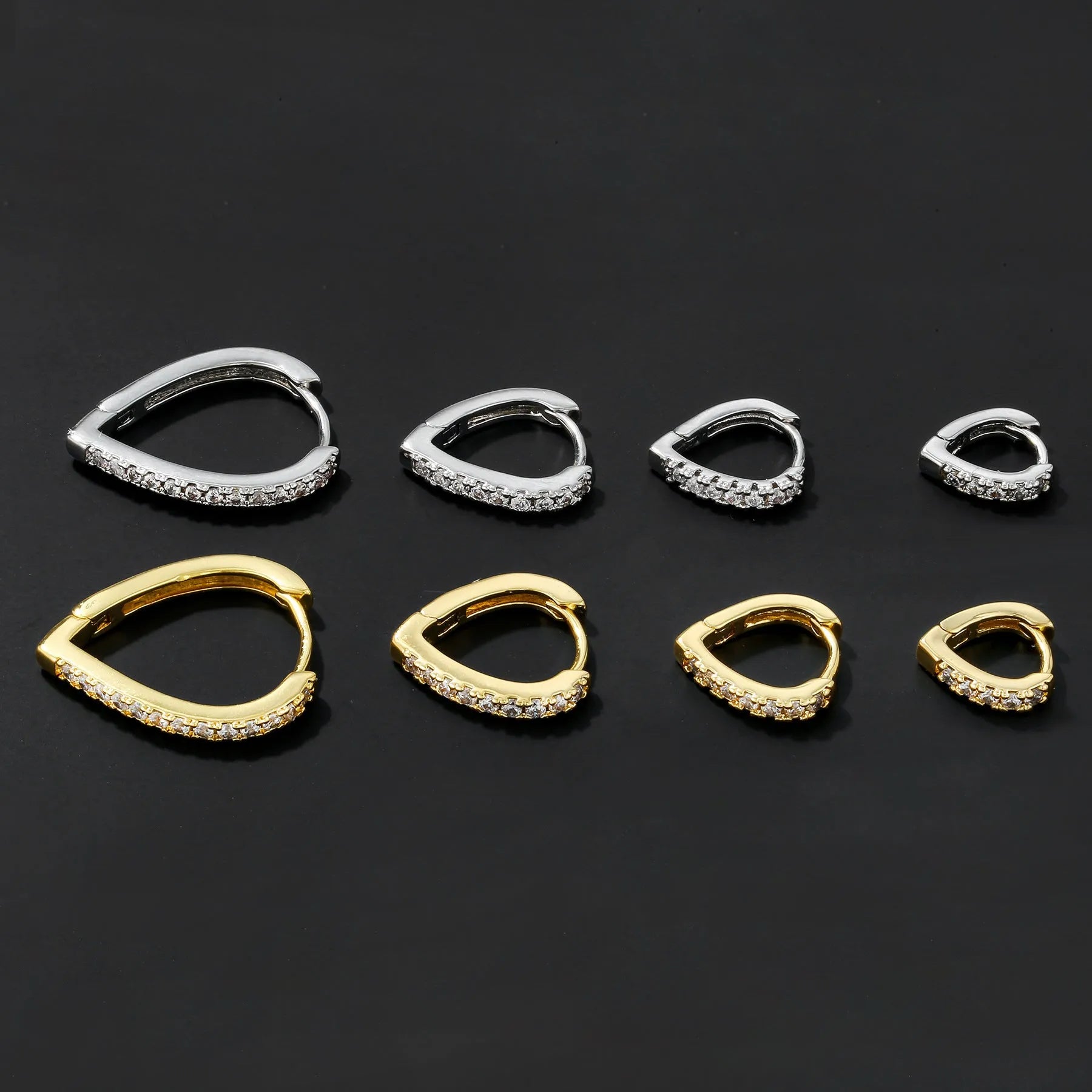 Geometric heart-shaped ear clips in gold and white colours on copper with clip back