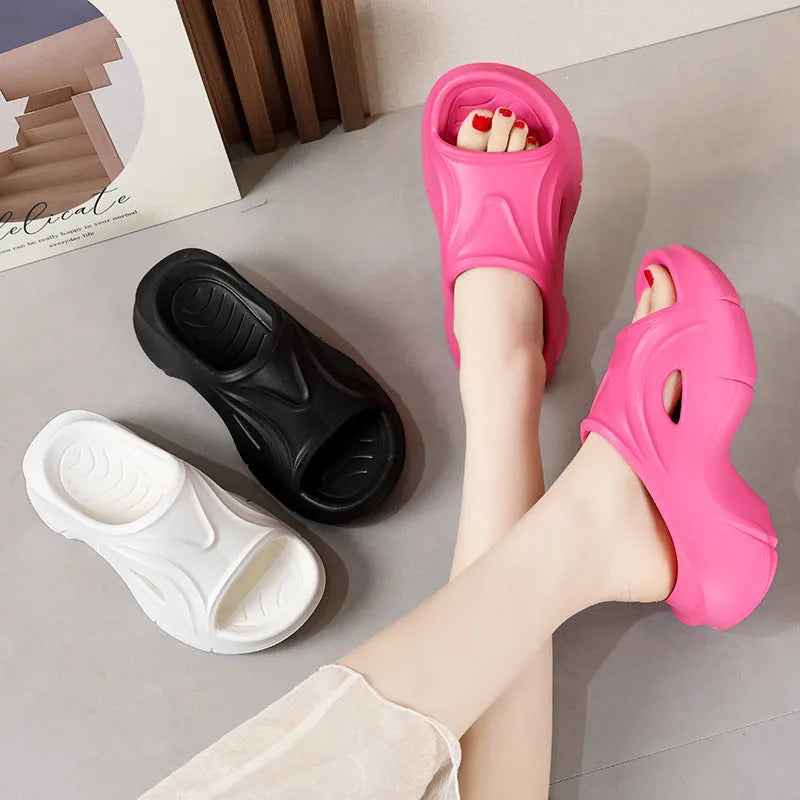 Women's white thick-soled EVA slippers with round toe on a beach background