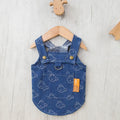Small white Bichon dog wearing a denim princess dress with bracket skirt design