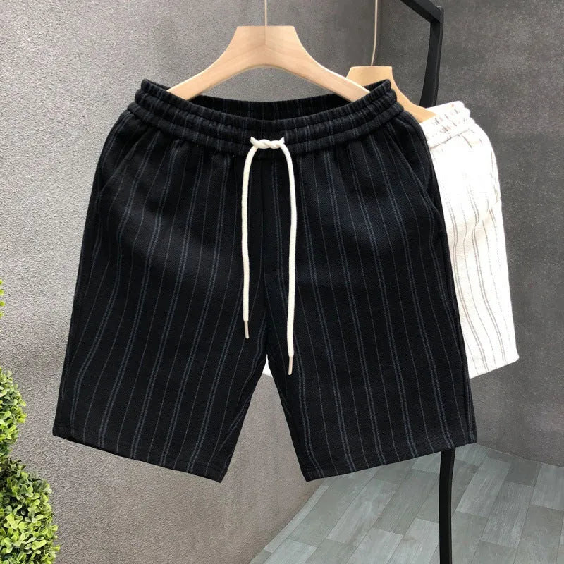 Man wearing black and white striped casual fleece-lined shorts with an elastic waistband.
