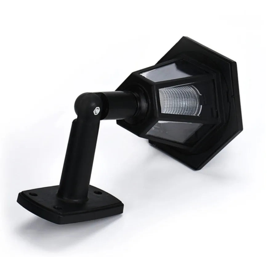 Black hexagonal solar-powered outdoor wall light with visible solar panel.
