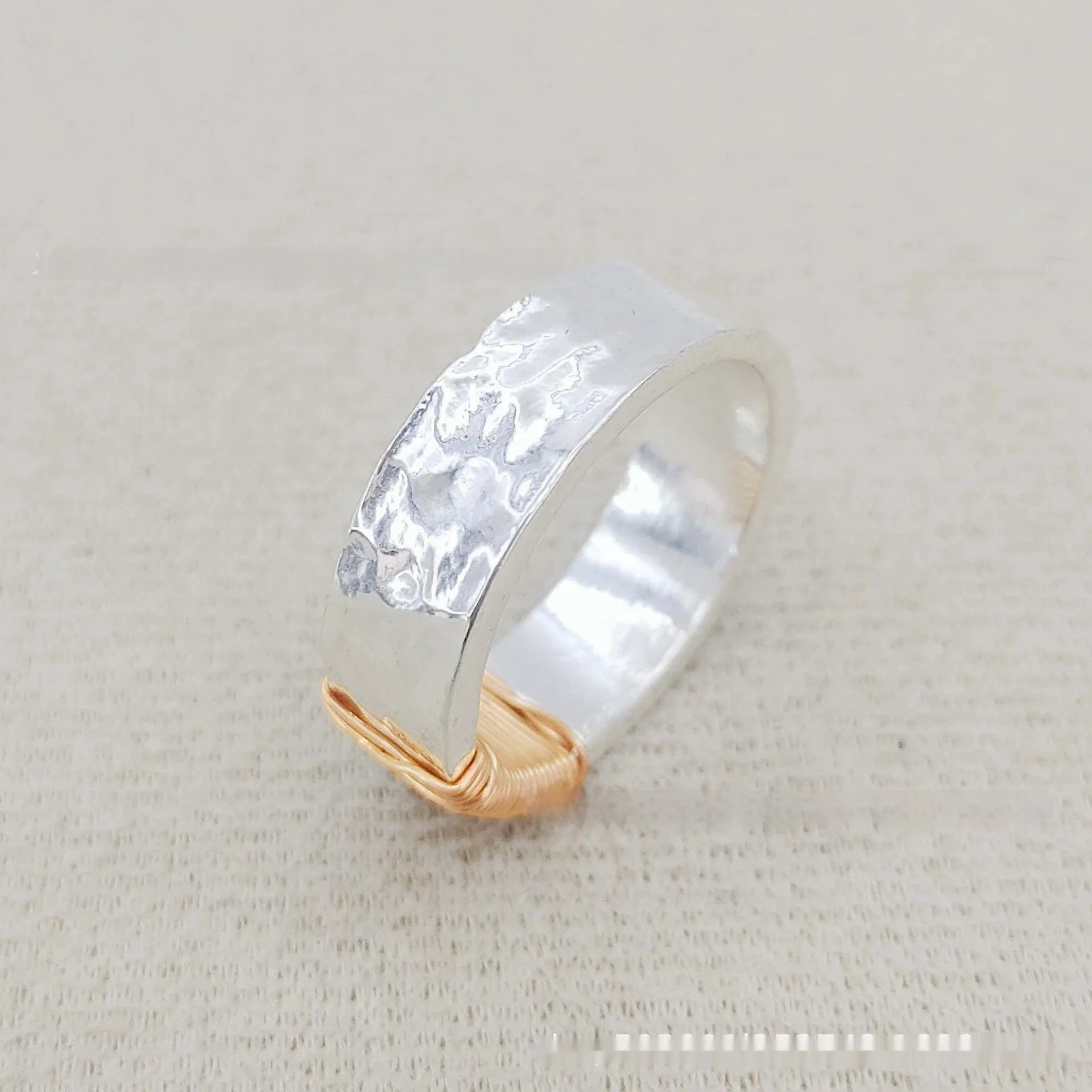 Geometric wide face copper bracelet ring with irregular coil design in silver gold finish.