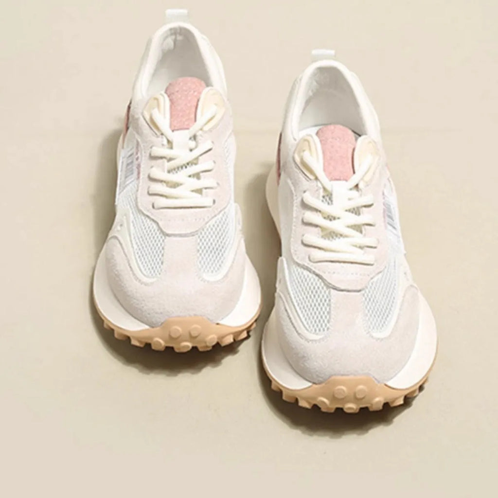 Women's gray retro sneaker with mesh lining and rubber sole on wooden floor