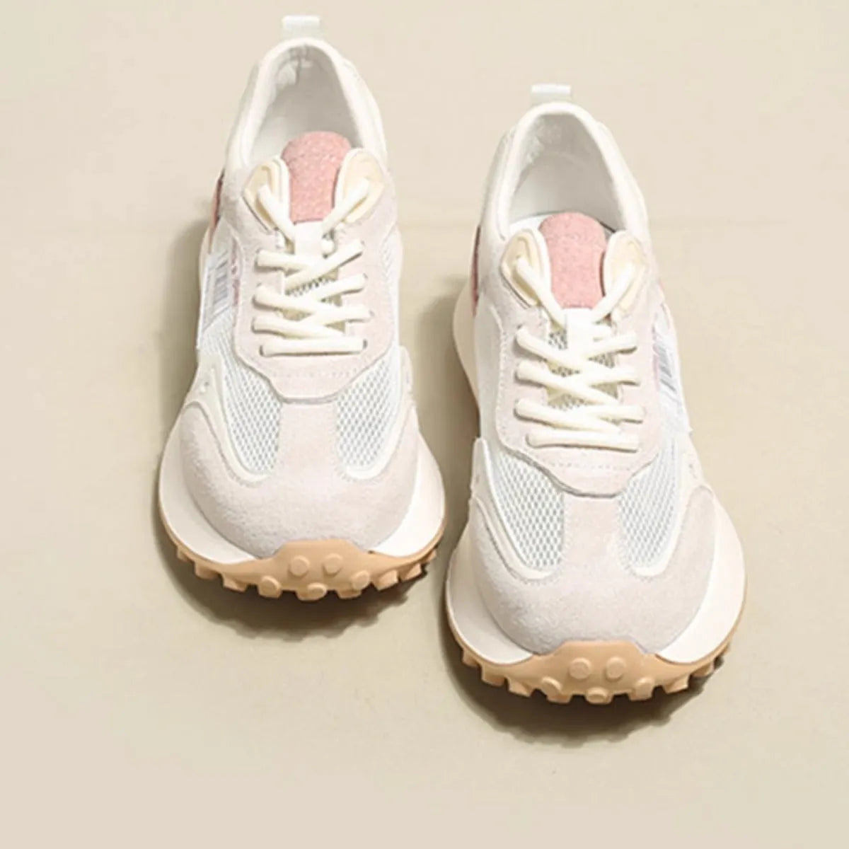 Women's gray retro sneaker with mesh lining and rubber sole on wooden floor
