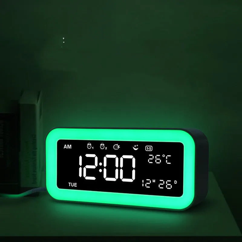 Blue rectangular LED atmosphere light and digital alarm clock on a table.