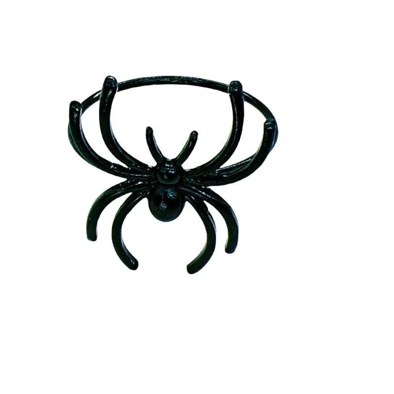 Six black alloy spider-shaped napkin rings for Halloween table decoration.