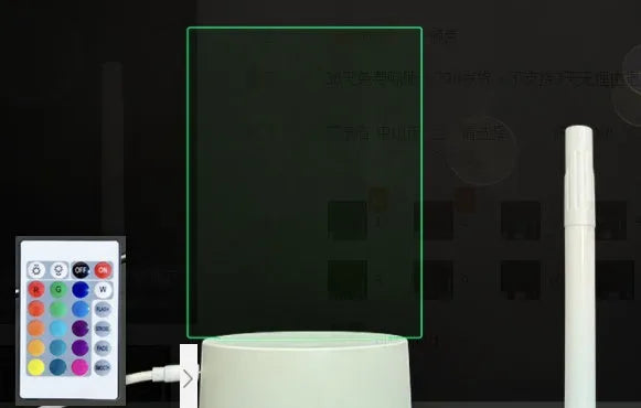 Black 3D acrylic LED night light and message board with stylus on a desktop