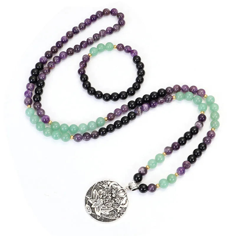 Long yoga lotus pendant necklace and matching bracelet set with stone beads and geometric design.