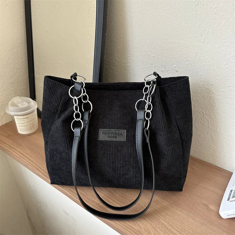 Corduroy one-shoulder tote bag with three-dimensional front pocket in street style design