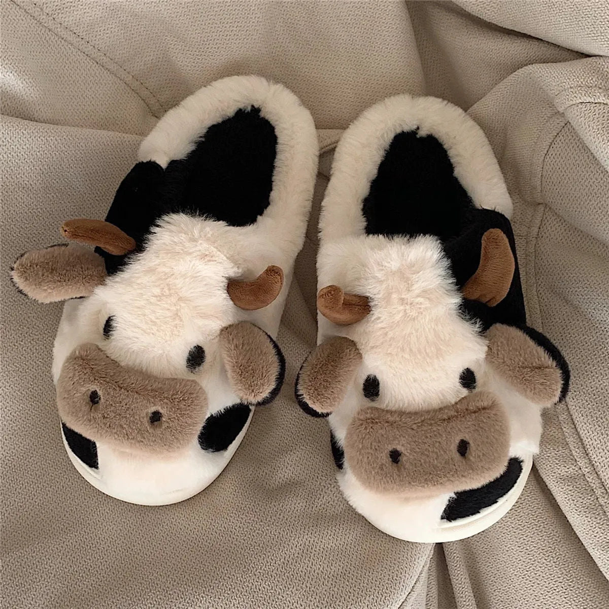 White cow animal house slippers with black spots, plush lining, and textured non-slip sole