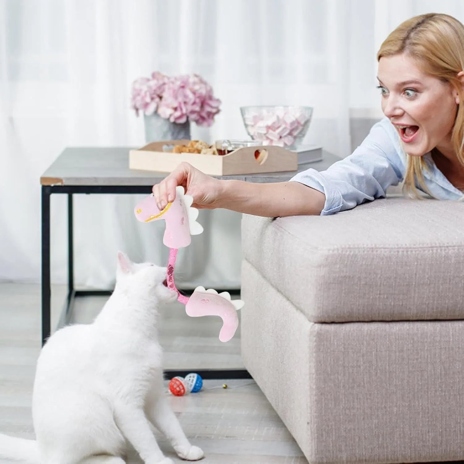 Set of four plush cat toys in pink, purple and yellow colours measuring 23cm long