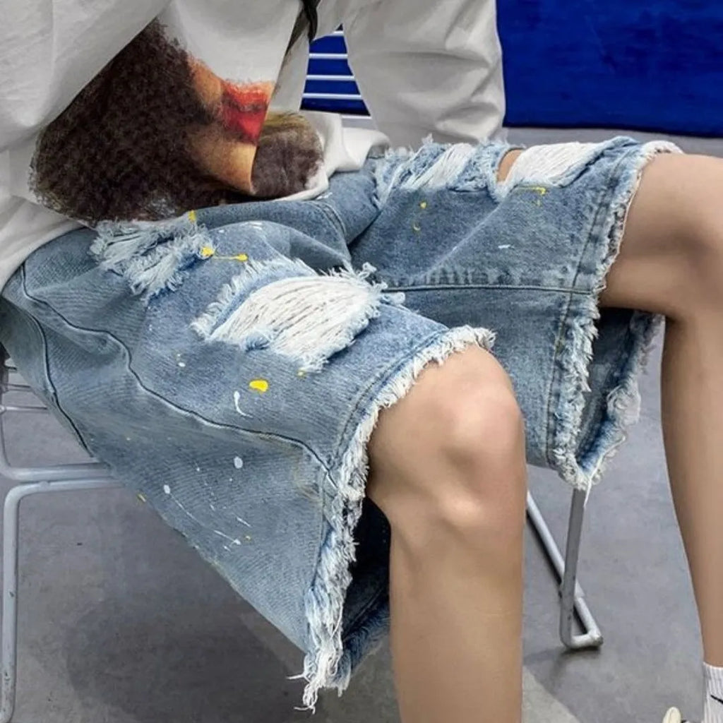 Men's loose fit denim shorts with water washed finish and distressed holes in light blue colour