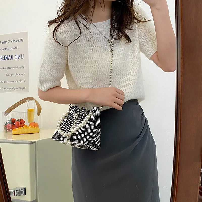 Light diamond PU crossbody shoulder bag with chain strap in bucket shape.