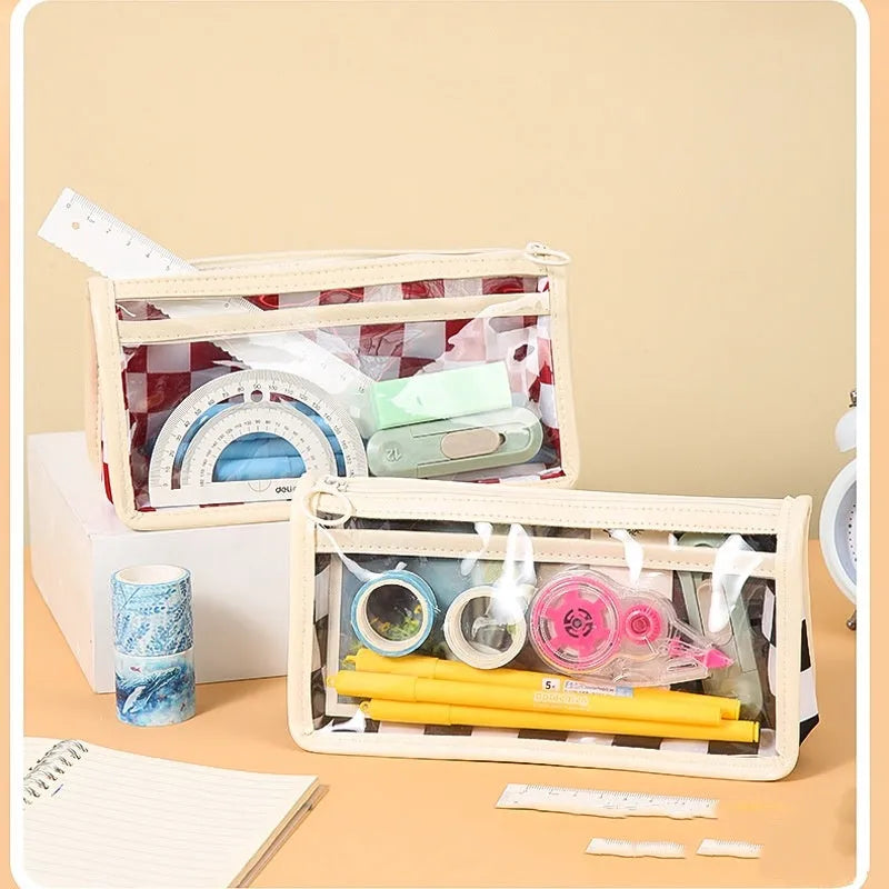Transparent PVC pencil case with chessboard grid pattern showing pens inside, dimensions 21.5cm x 8cm x 11.5cm