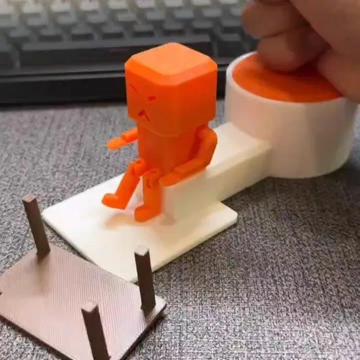Orange plastic rotating decompression toy on a desk, showing its 16cm length.