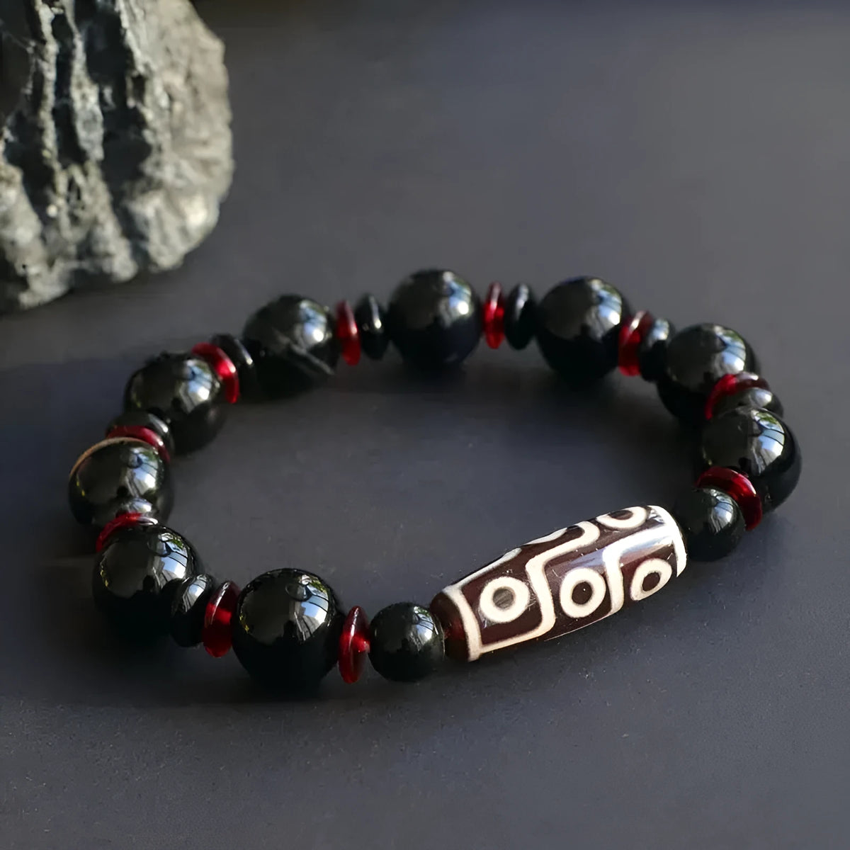 Hand-woven black agate Dzi bracelet with geometric 11mm beads on wrist