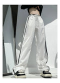 Women's loose straight trousers with ribbon parallel bars detailing in thin draping fabric