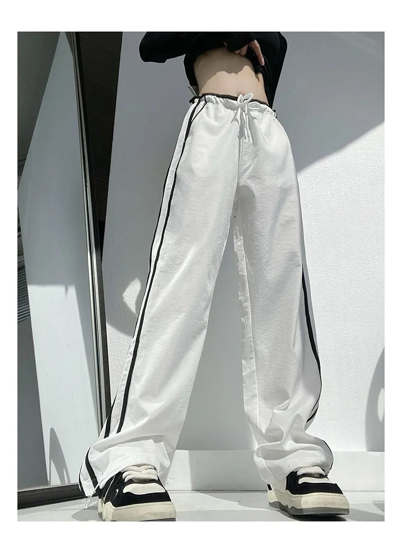 Women's loose straight trousers with ribbon parallel bars detailing in thin draping fabric