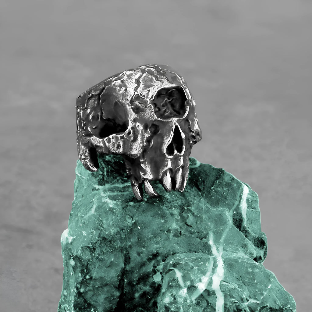 Alloy skull ring with one-eyed design in silver electroplated finish shown on finger