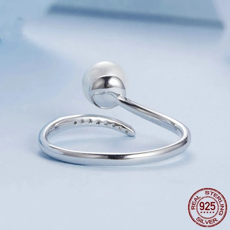 Sterling silver adjustable pearl ring with open loop design showing natural shell pearls on S925 silver band