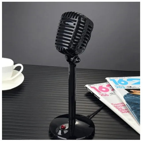 Black USB computer microphone with adjustable stand on desktop for recording and podcasting